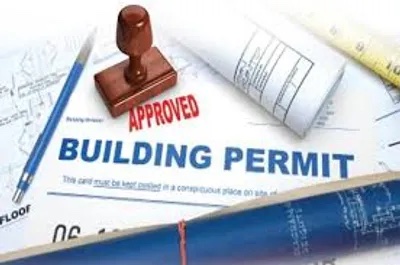 approved stamp on top of construction blueprints